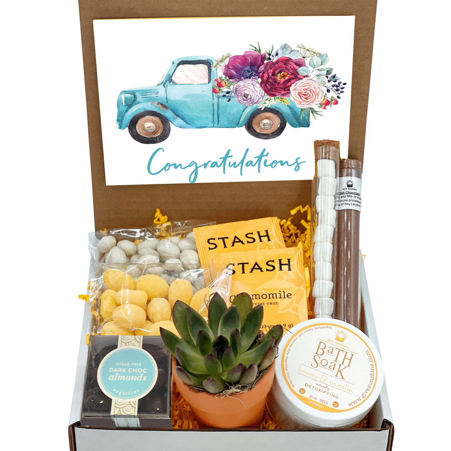 A gift box containing various items including a 'Sending you a little box of SUNSHINE' notecard, a 2.5-Inch Succulent in a Terra Cotta Pot, Honey & Vanilla Bath Soak, Dark Chocolate Covered Almonds, Hot Chocolate and Marshmallows, Lemon Drop Candies, Yogurt Covered Raisins, Chamomile Tea, and a 'Bit of Honey' candy.