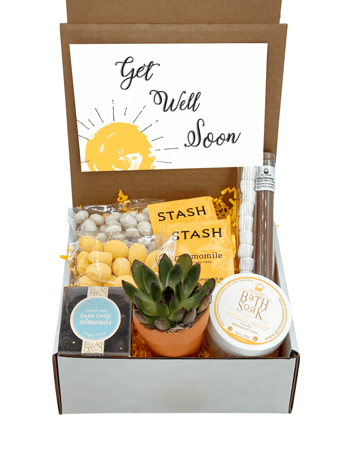 A gift box containing various items including a 'Sending you a little box of SUNSHINE' notecard, a 2.5-Inch Succulent in a Terra Cotta Pot, Honey & Vanilla Bath Soak, Dark Chocolate Covered Almonds, Hot Chocolate and Marshmallows, Lemon Drop Candies, Yogurt Covered Raisins, Chamomile Tea, and a 'Bit of Honey' candy.